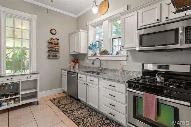 111 Portland Ave, Belleville, IL 62220 - kitchen with stainless steel appliances, a sink, crown molding, light tile patterned floors, and white cabinetry