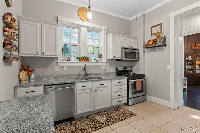 111 Portland Ave, Belleville, IL 62220 - kitchen featuring appliances with stainless steel finishes, a sink, white cabinets, light tile patterned floors, and ornamental molding