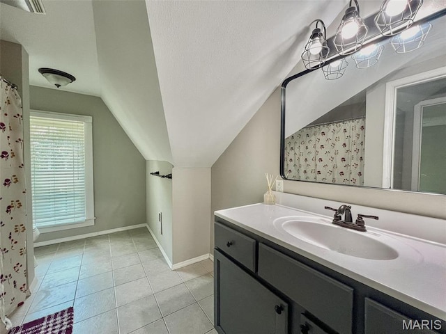 111 Portland Ave, Belleville, IL 62220 - full bath with vaulted ceiling, baseboards, vanity, tile patterned floors, and a shower with shower curtain