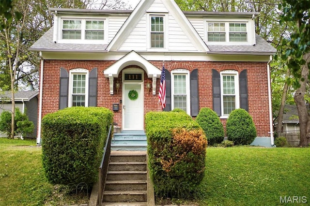 111 Portland Ave, Belleville, IL 62220 - view of front of home featuring brick siding, a front yard, and roof with shingles