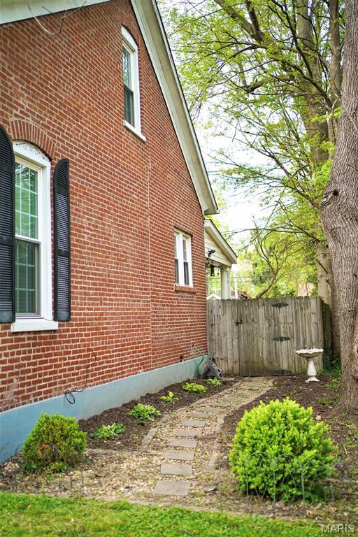 111 Portland Ave, Belleville, IL 62220 - view of home's exterior featuring brick siding and fence