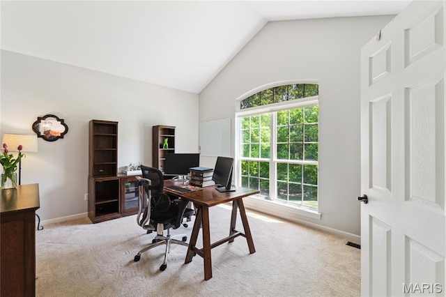 office space featuring light colored carpet, high vaulted ceiling, and baseboards