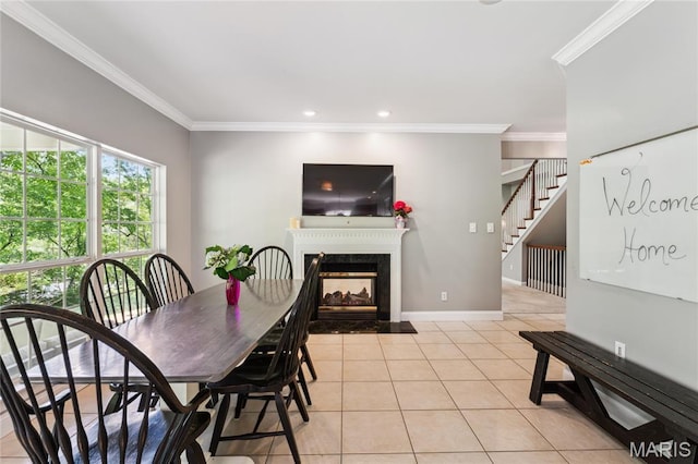 dining space with ornamental molding, light tile patterned flooring, a high end fireplace, recessed lighting, and baseboards