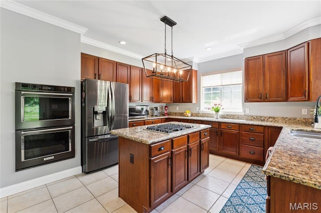 kitchen featuring stainless steel appliances, crown molding, light stone countertops, a sink, and a center island