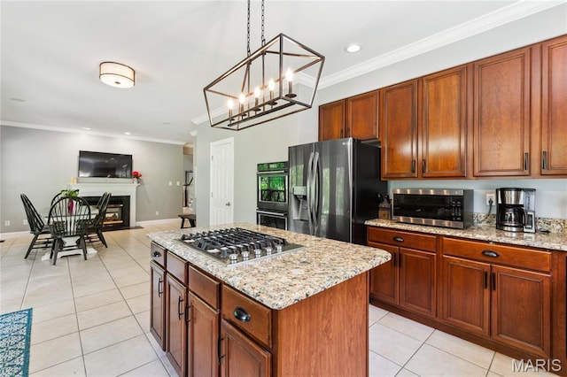 kitchen with stainless steel appliances, light tile patterned floors, crown molding, a kitchen island, and light stone counters