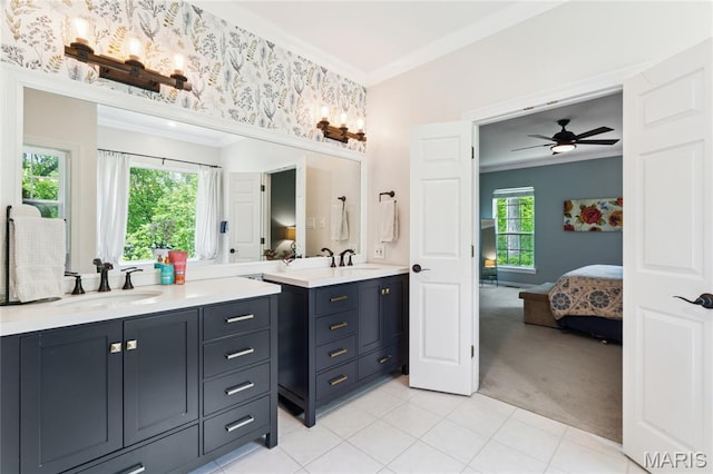 bathroom with crown molding, ensuite bath, vanity, a ceiling fan, and tile patterned floors