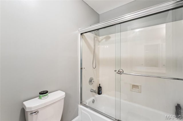 full bathroom featuring combined bath / shower with glass door and toilet