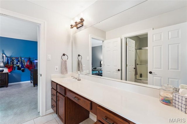full bathroom featuring vanity, tile patterned floors, and baseboards