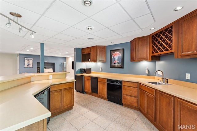 kitchen featuring a sink, dishwasher, light tile patterned floors, light countertops, and fridge