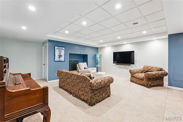 carpeted living area featuring baseboards, recessed lighting, and a drop ceiling