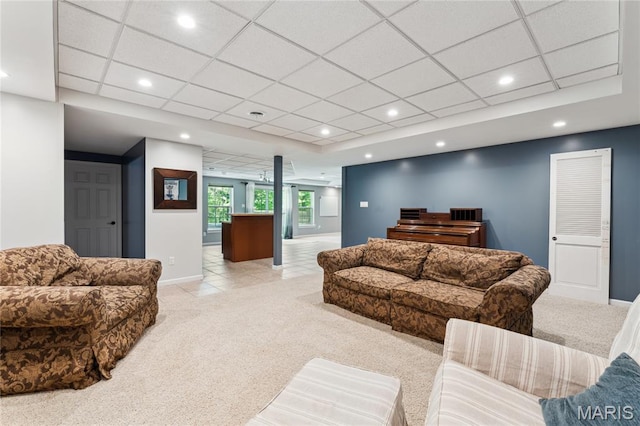 living area with light carpet, baseboards, recessed lighting, a drop ceiling, and ornate columns