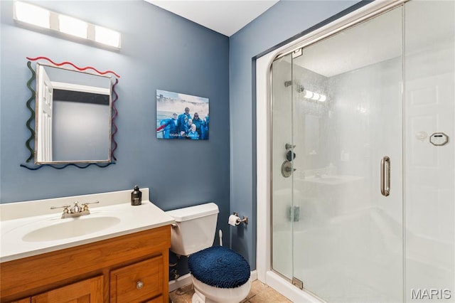 full bathroom with a shower stall, toilet, vanity, and tile patterned floors