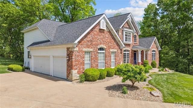 view of front of house featuring a garage, brick siding, driveway, a shingled roof, and a front lawn