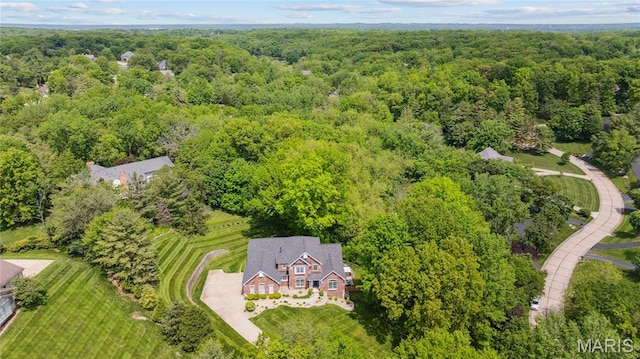 aerial overview of property's location with a heavily wooded area