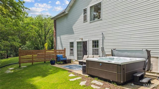 back of house with a hot tub