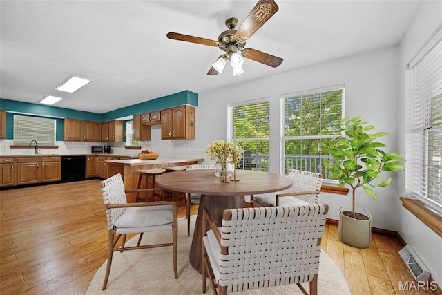 dining room with light wood-type flooring and ceiling fan