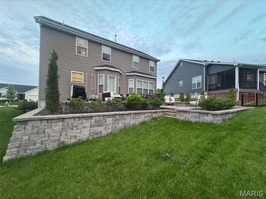 back of house featuring a yard and a patio area