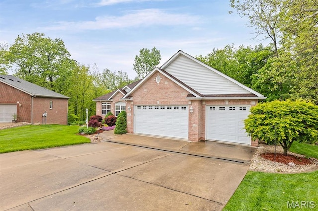 view of front of property featuring brick siding, a front yard, driveway, and a garage
