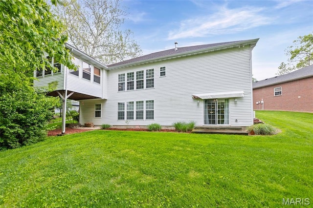 back of house with a yard