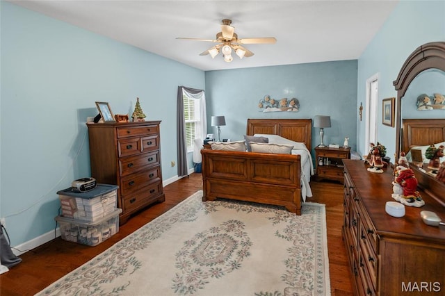 bedroom featuring dark wood finished floors, baseboards, and a ceiling fan
