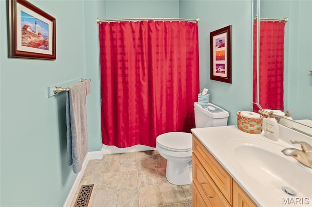 bathroom featuring toilet, vanity, and a shower with curtain