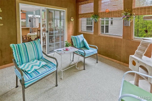 sunroom featuring a chandelier