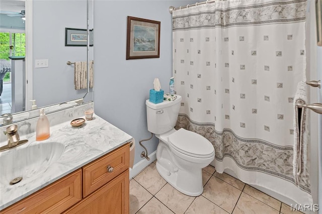 bathroom with toilet, a ceiling fan, tile patterned flooring, vanity, and curtained shower