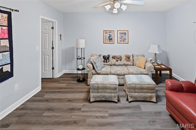 living area featuring ceiling fan, wood finished floors, and baseboards
