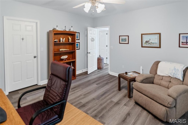 office with a ceiling fan, wood finished floors, and baseboards