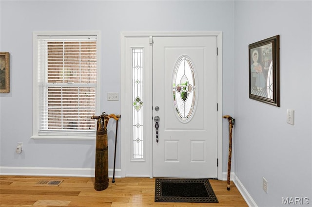 foyer entrance featuring light wood-type flooring and baseboards