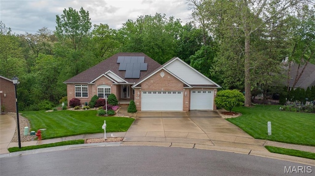 view of front of house featuring brick siding, concrete driveway, an attached garage, a front yard, and solar panels