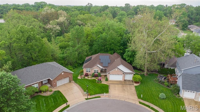 view of property location with a forest