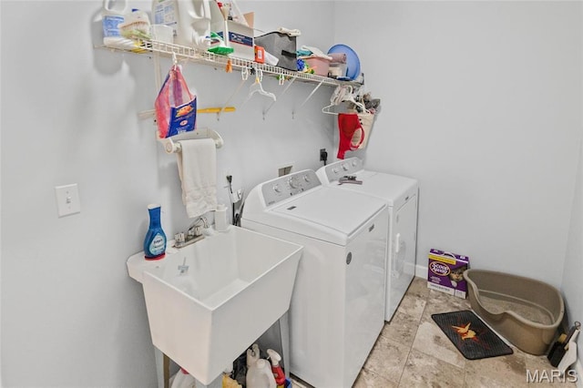 clothes washing area with washing machine and dryer