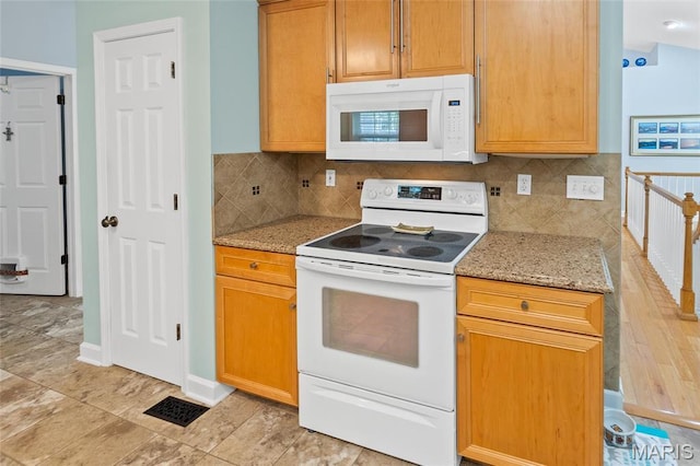 kitchen with white appliances, light stone countertops, decorative backsplash, and baseboards