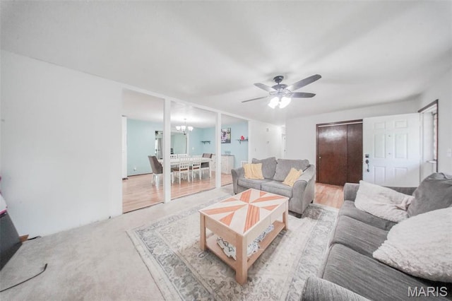 living area with a chandelier and a ceiling fan