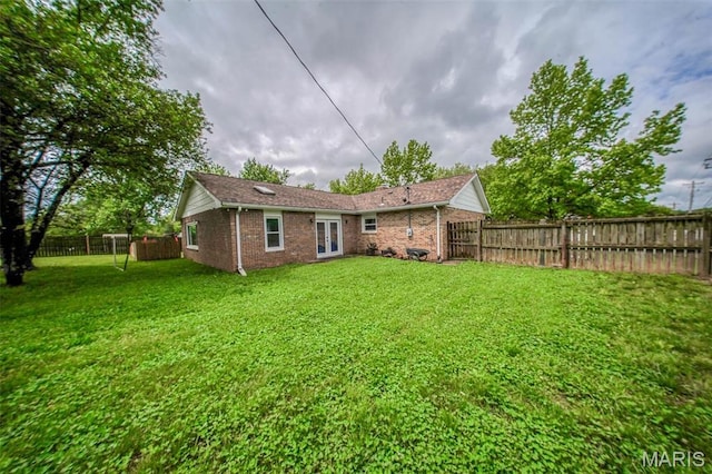 rear view of property with french doors and brick siding