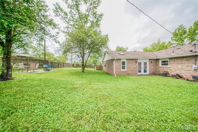 view of yard featuring french doors and a patio
