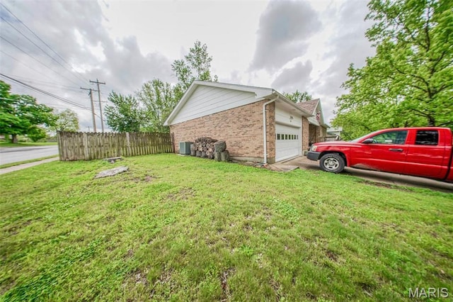 view of home's exterior with brick siding, central air condition unit, and an attached garage