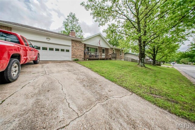 single story home featuring a chimney, an attached garage, concrete driveway, and brick siding