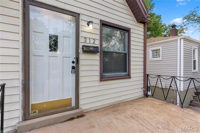 312 Waller Ave, Saint Louis, MO 63125 - doorway to property featuring a patio and a chimney