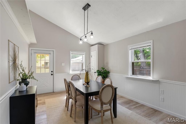 312 Waller Ave, Saint Louis, MO 63125 - dining area featuring a wainscoted wall, light wood-style floors, healthy amount of natural light, and lofted ceiling