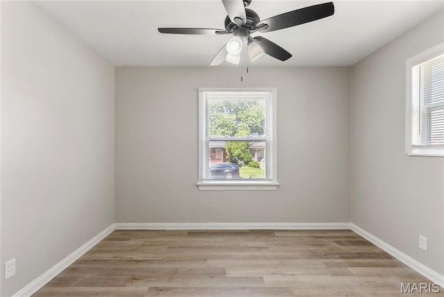 312 Waller Ave, Saint Louis, MO 63125 - empty room with light wood-style flooring, a ceiling fan, and baseboards