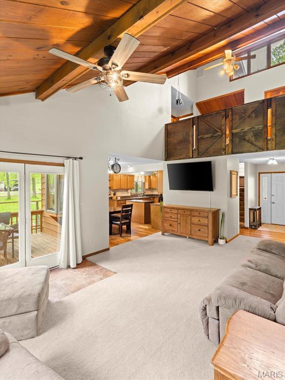 22000 E Rd, Carlyle, IL 62231 - living area featuring wood ceiling, light colored carpet, beam ceiling, ceiling fan, and high vaulted ceiling