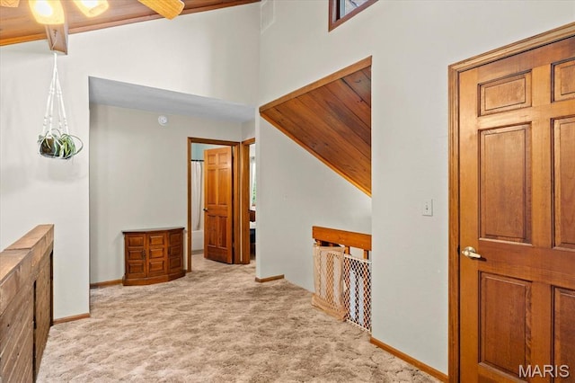22000 E Rd, Carlyle, IL 62231 - hall featuring carpet flooring, high vaulted ceiling, and baseboards