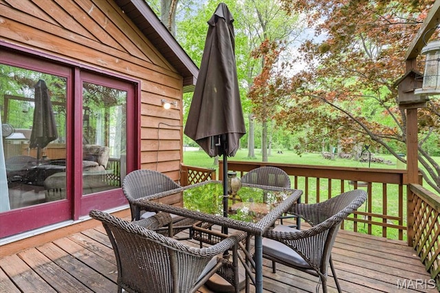 22000 E Rd, Carlyle, IL 62231 - wooden deck with outdoor dining area and a lawn