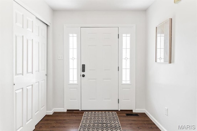 entrance foyer with healthy amount of natural light, baseboards, and dark wood finished floors