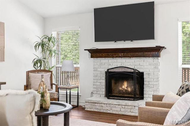 sitting room with wood finished floors and a fireplace
