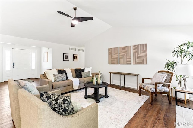 living area featuring vaulted ceiling, a ceiling fan, and wood finished floors