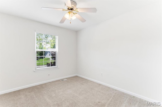 spare room with carpet floors, baseboards, and ceiling fan
