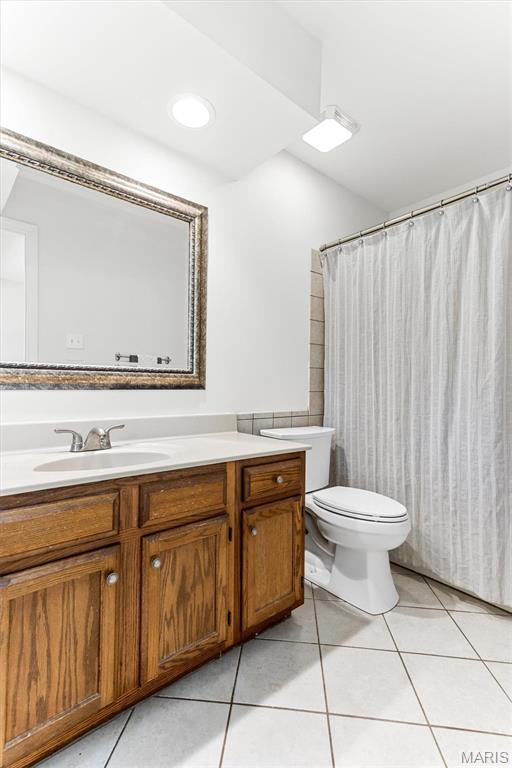 bathroom featuring tile patterned floors, toilet, and vanity